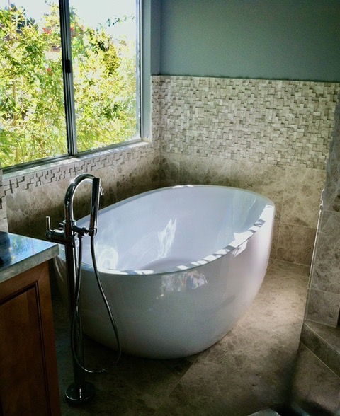 Freestanding soaking tub with floor-mounted filler installed by So-Cal Plumbing